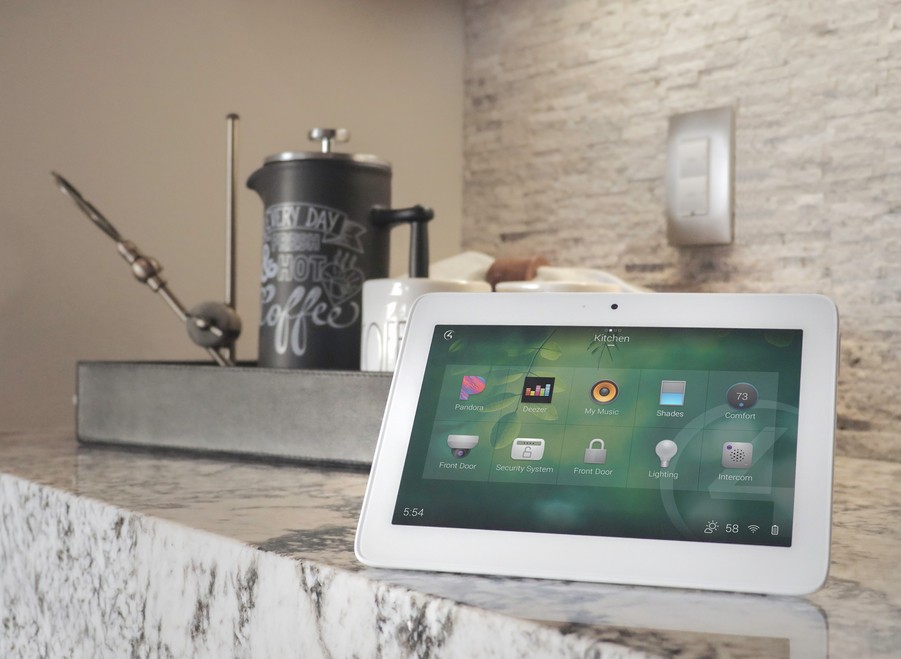 Control4 ipad interface sitting on a countertop with a coffee caddy behind it