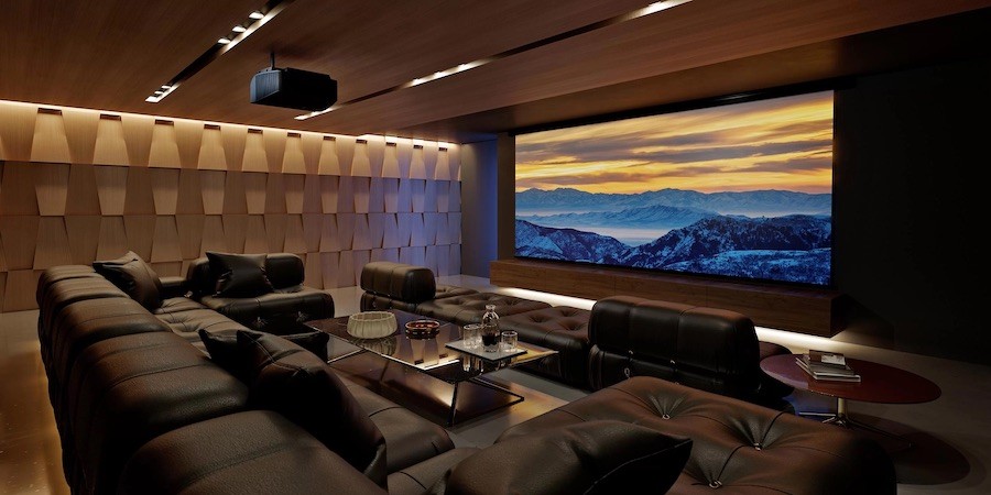 high-end home theater with sectional seating, projector, and projection screen.