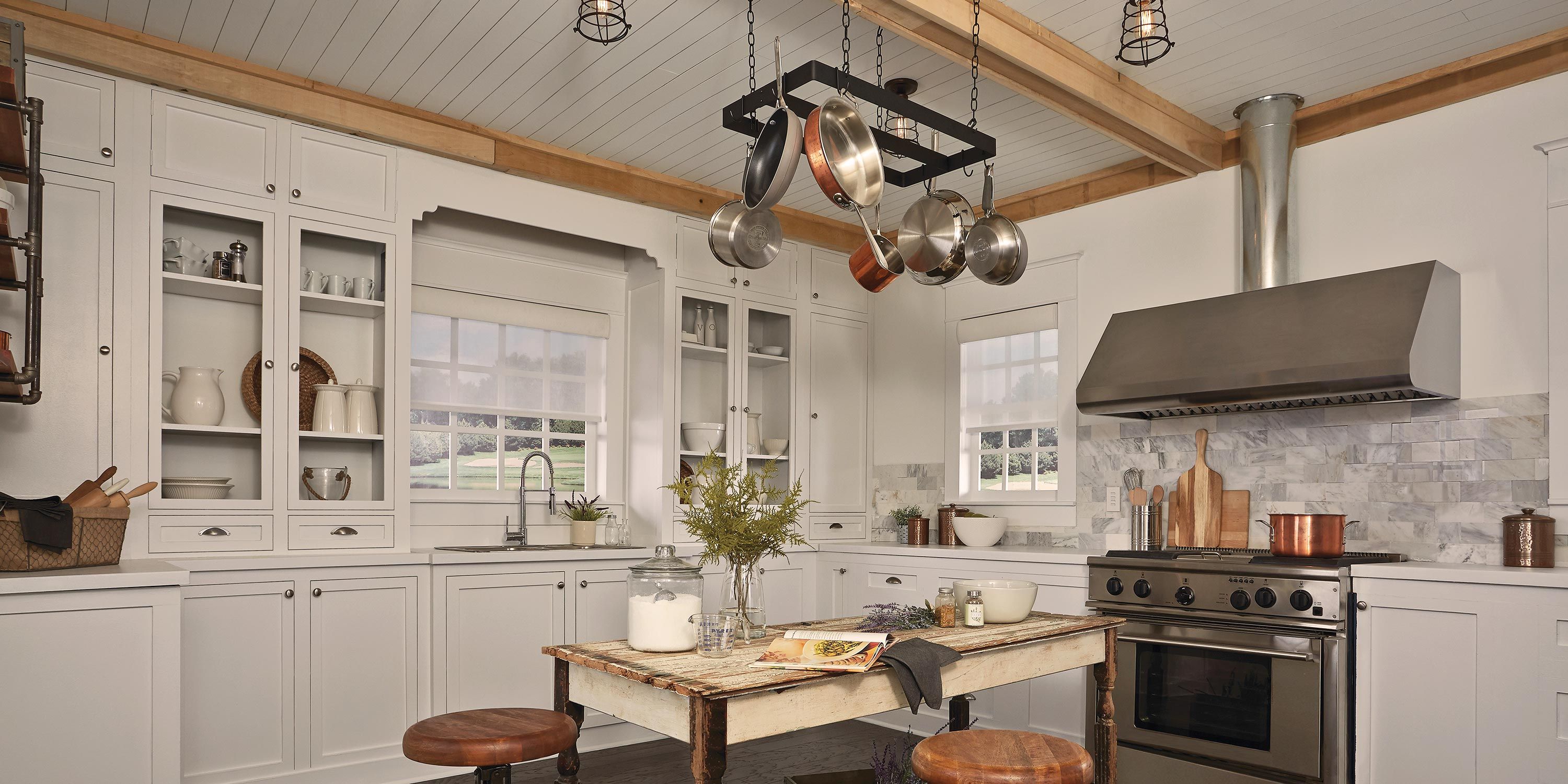 Lutron Kitchen in white with pans hanging from the ceiling